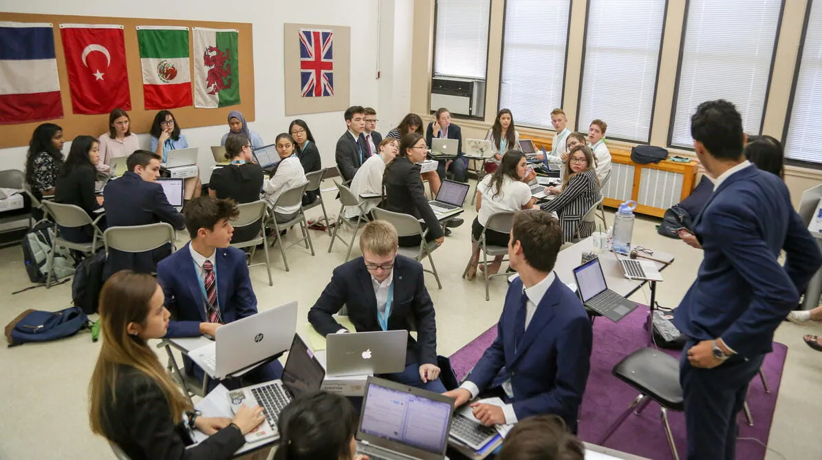 Students sitting in groups during Model UN event